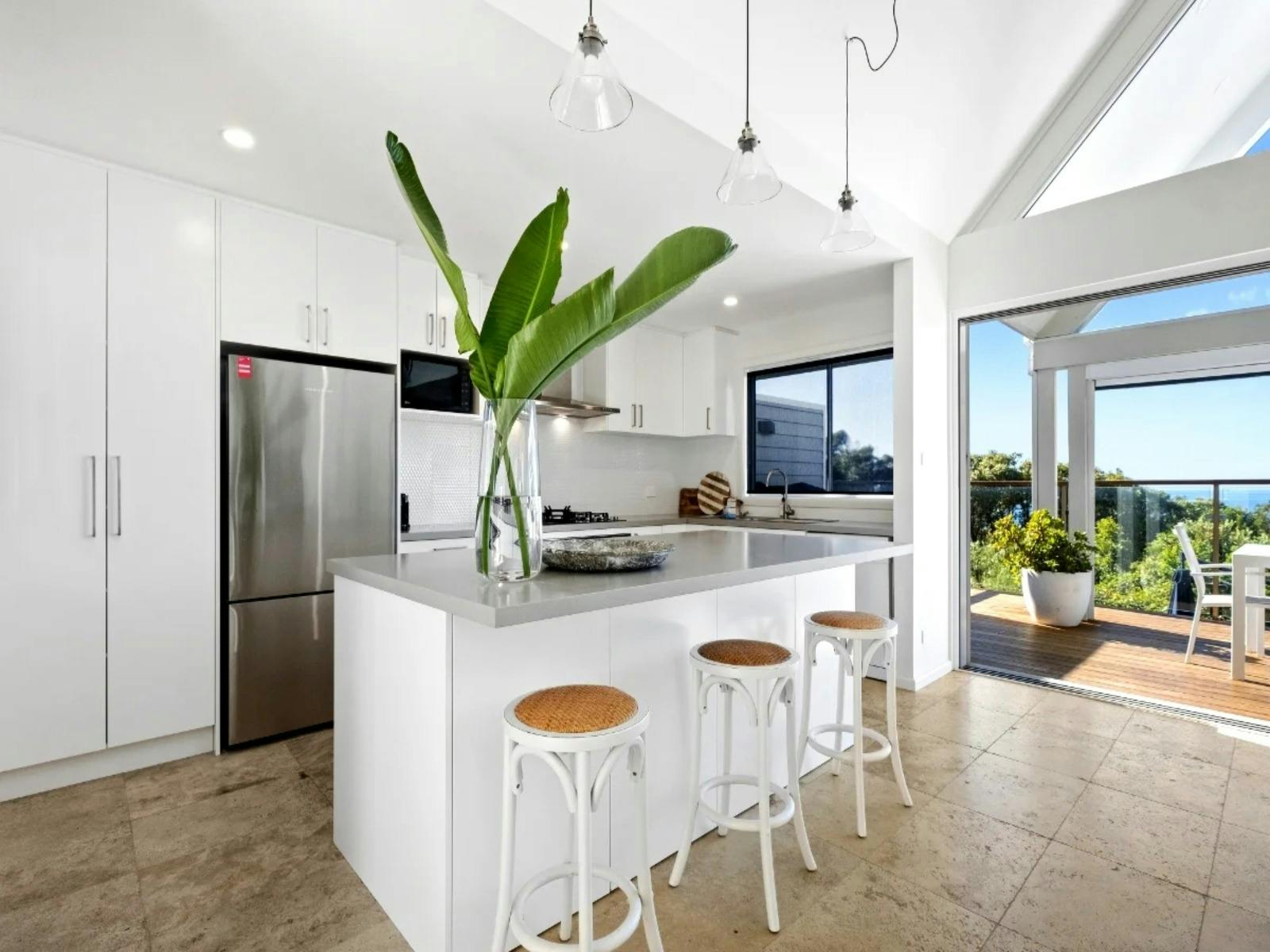 Modern, open-plan kitchen featuring brand-new appliances and sleek kitchenware