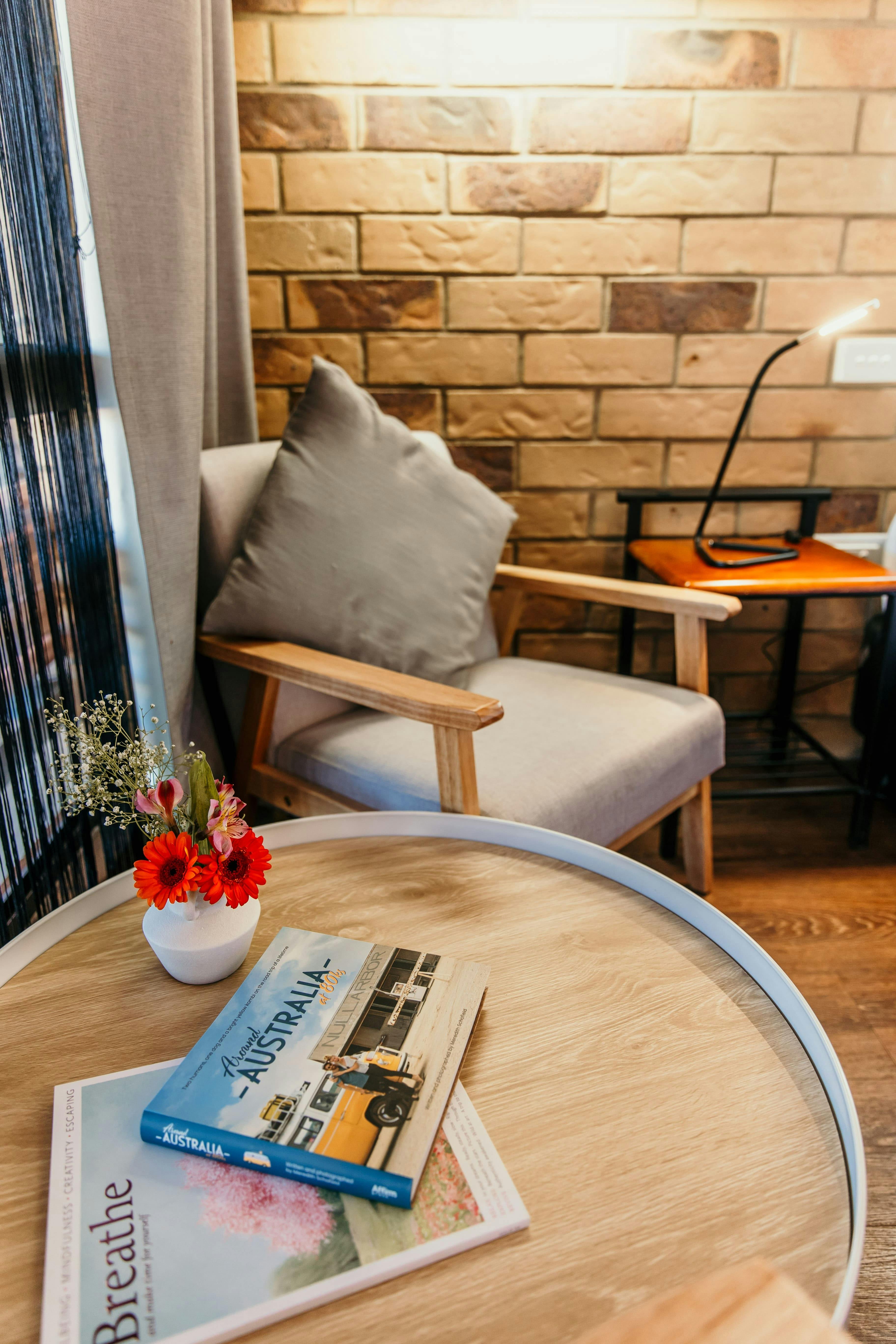 Sitting area with flowers sitting on a coffee table.