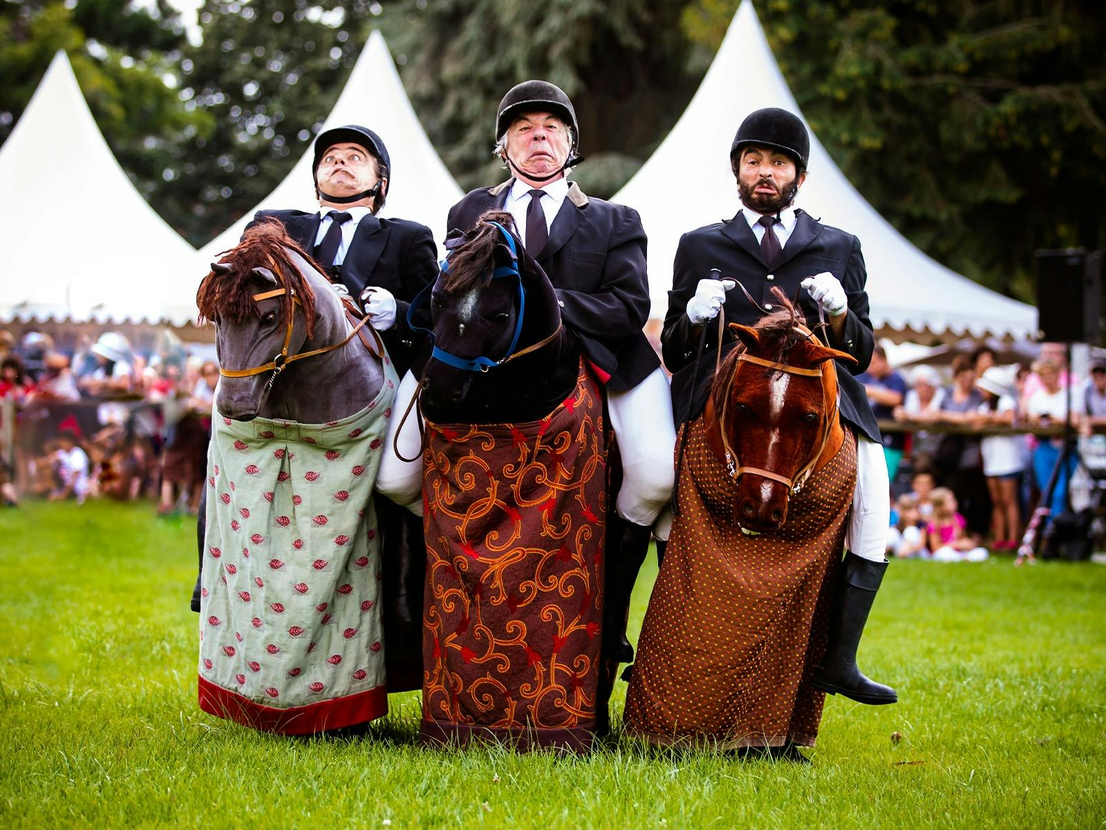 Three men riding on fake horses