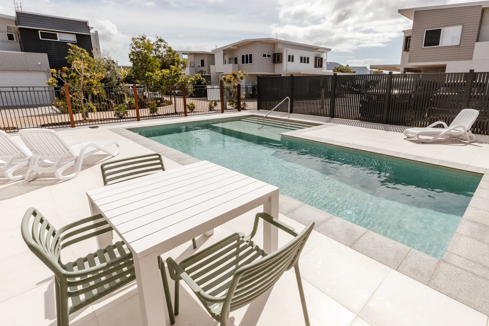 Shared outdoor pool with sun loungers