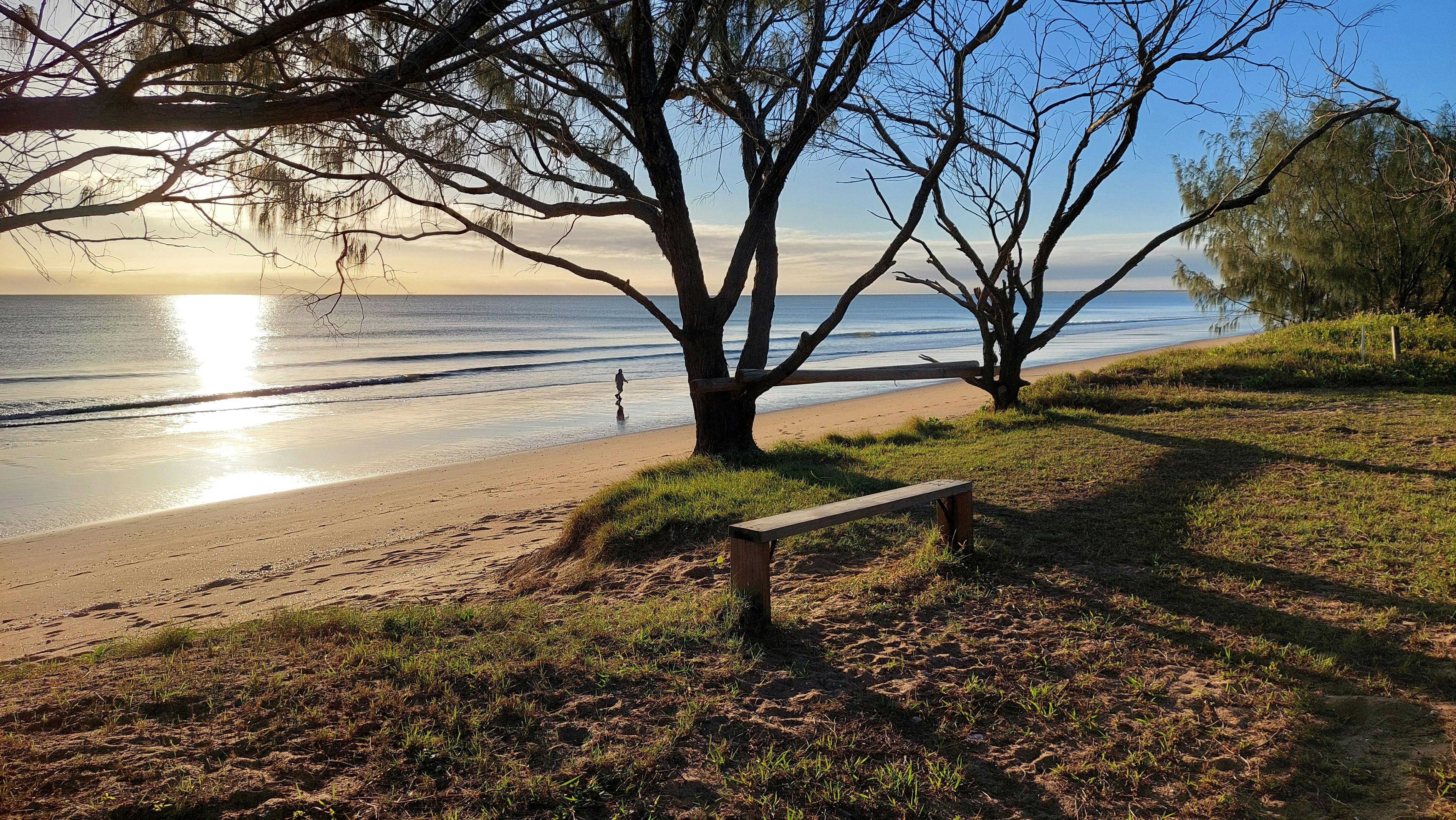 Sit and watch the sun rise over the calm wate rs of the Coral Sea at Moore Park Beach