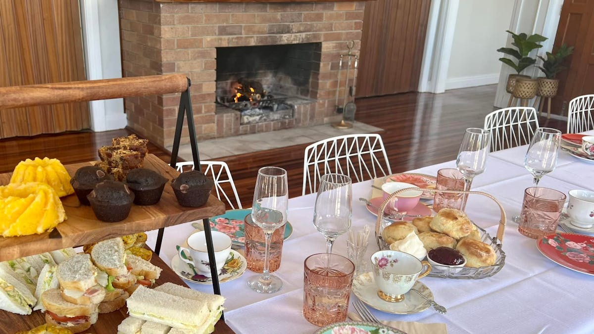 High Tea set up on a table with an open fire in the background at the Old RSL Cunnamulla