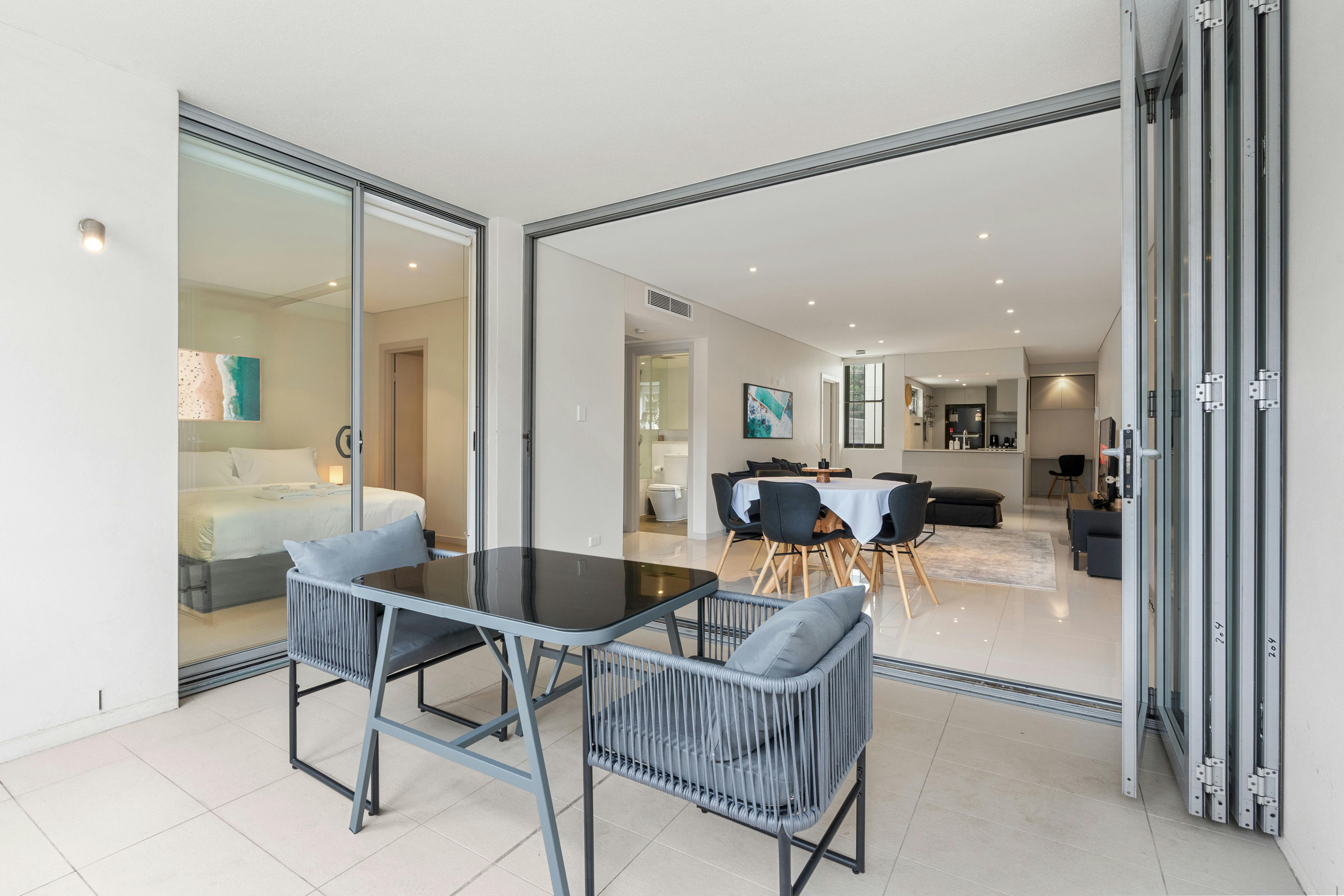 Elegant outdoor dining space opening into the bright, airy apartment.