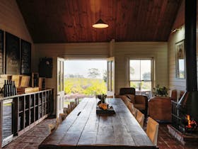 Image of tasting room showing tasting table and view of the vineyard though the french doors.