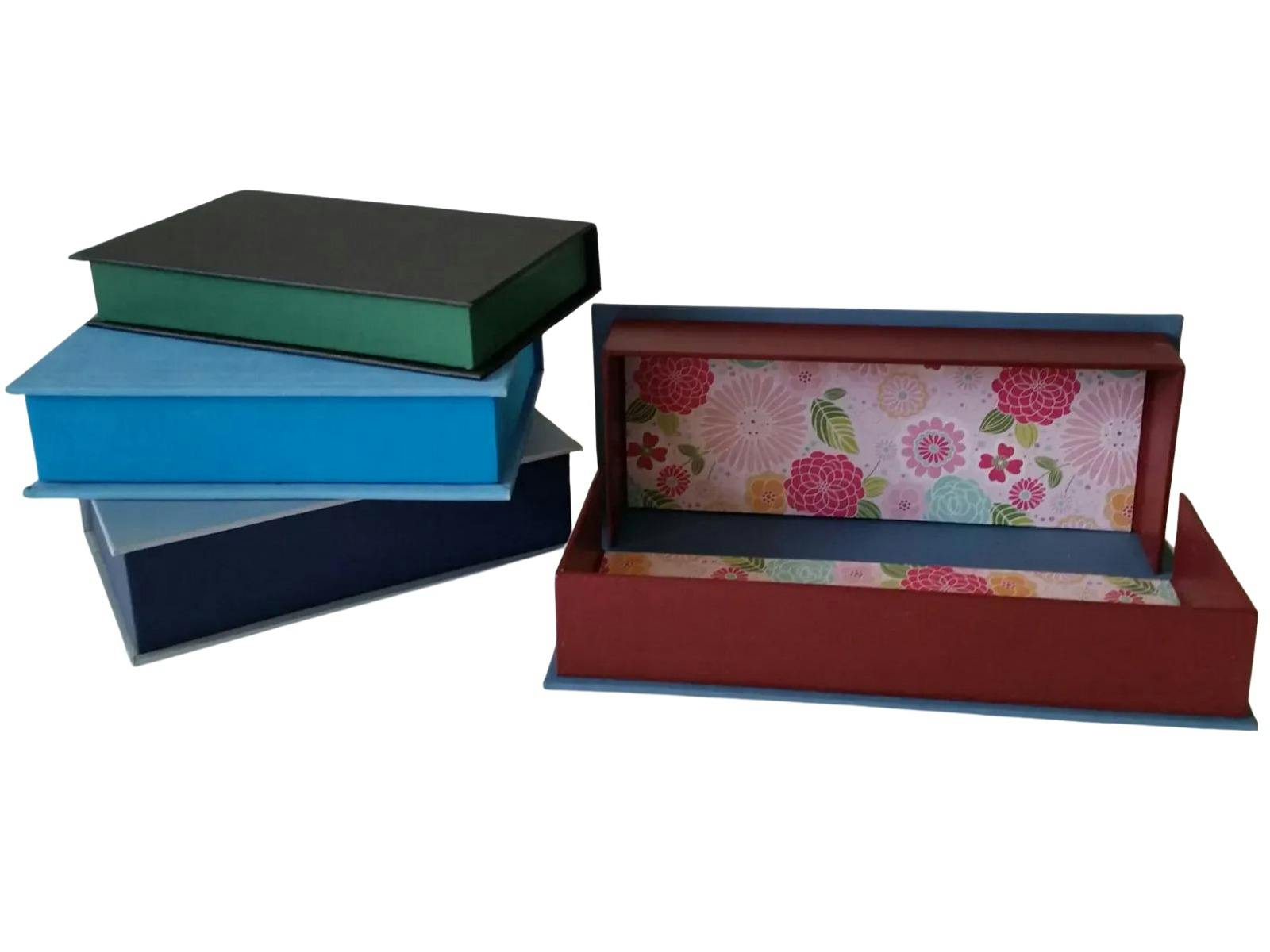 Set of four cloth covered storage boxes