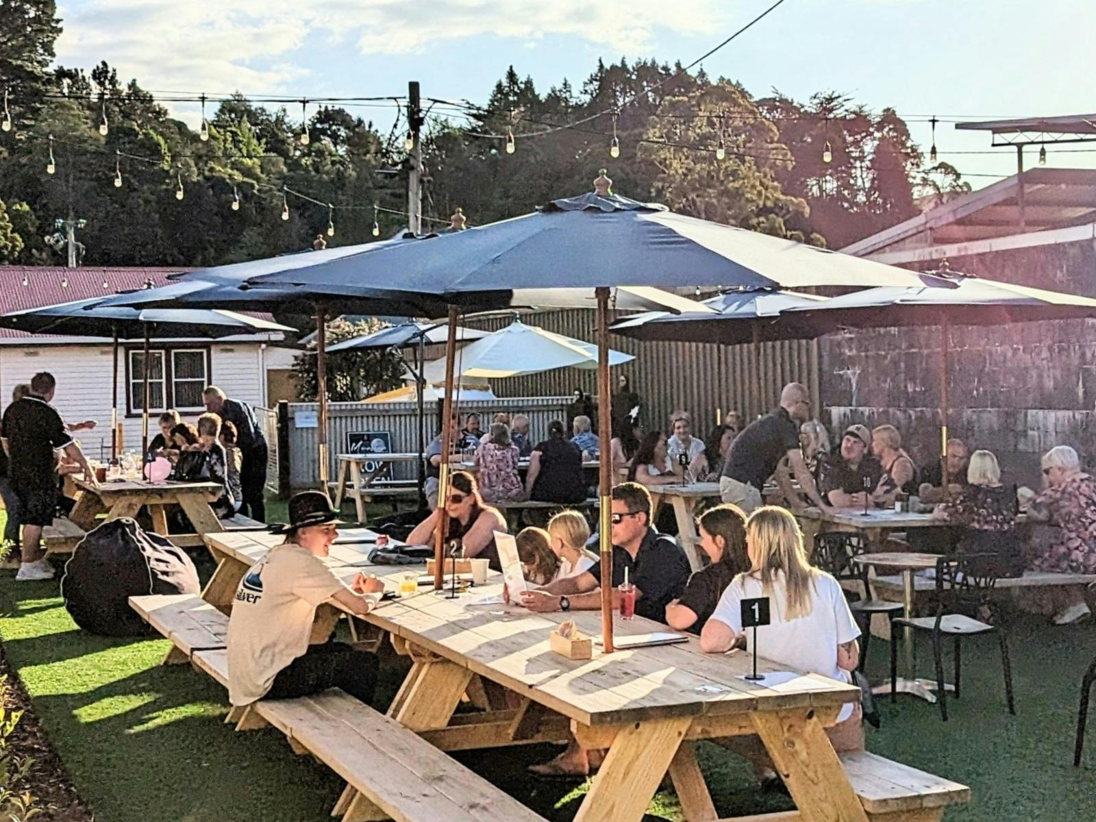 Lots of people including families having fun on a warm sunny evening