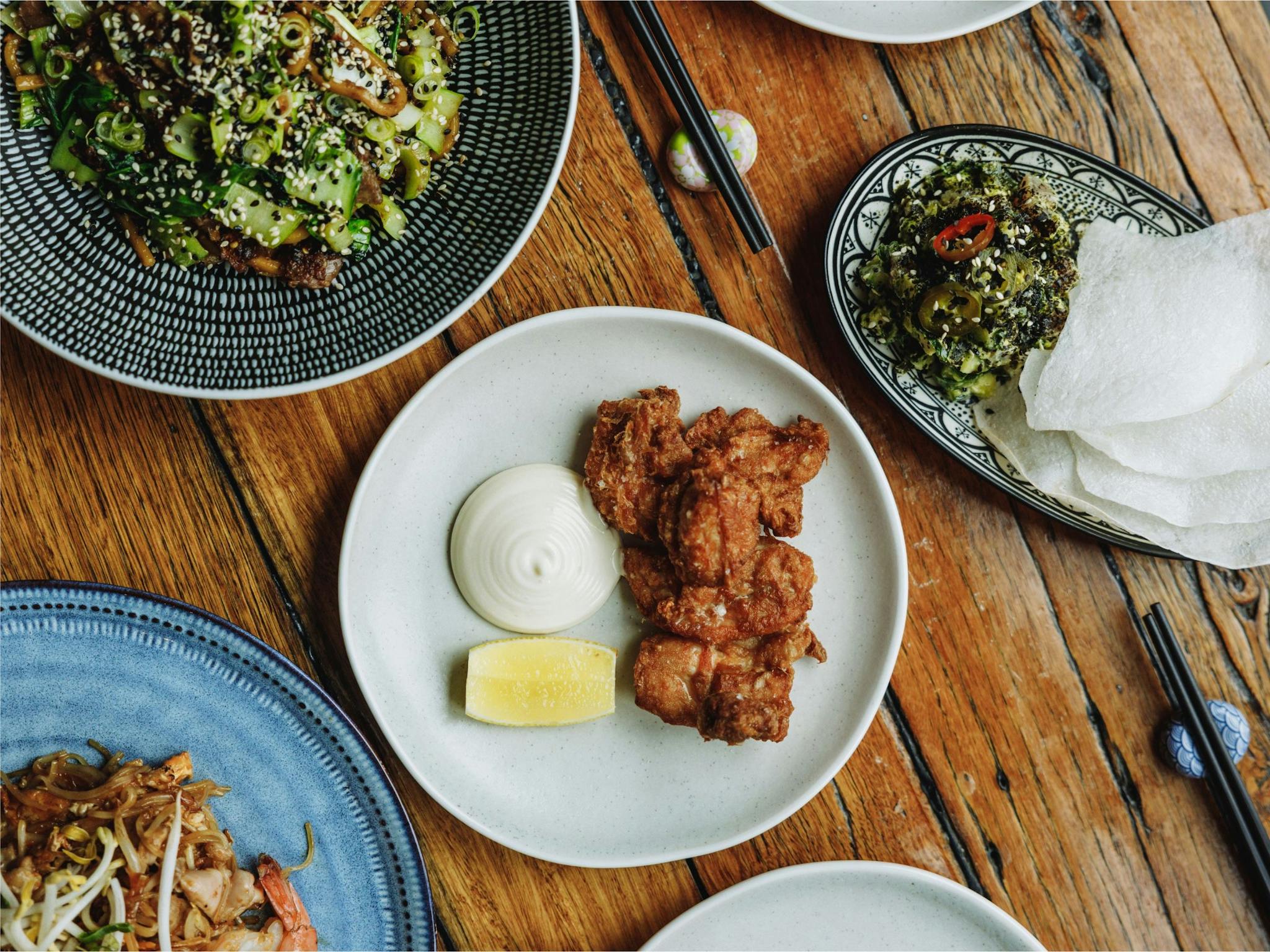 An image of South East Asian dishes on the table at Huski Kitchen