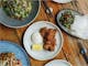 An image of South East Asian dishes on the table at Huski Kitchen
