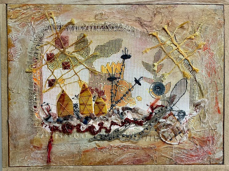 Canvas stitches and painted border create a beach scene illuminated by a hidden light