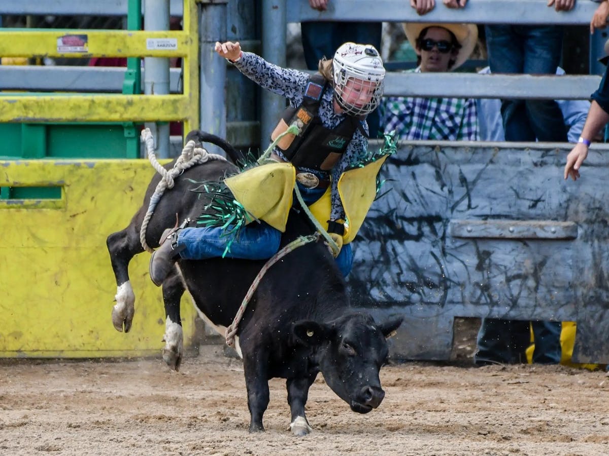 A girl rides a calf at the Mareeba Rodeo, Mareeba Far North Queensland.