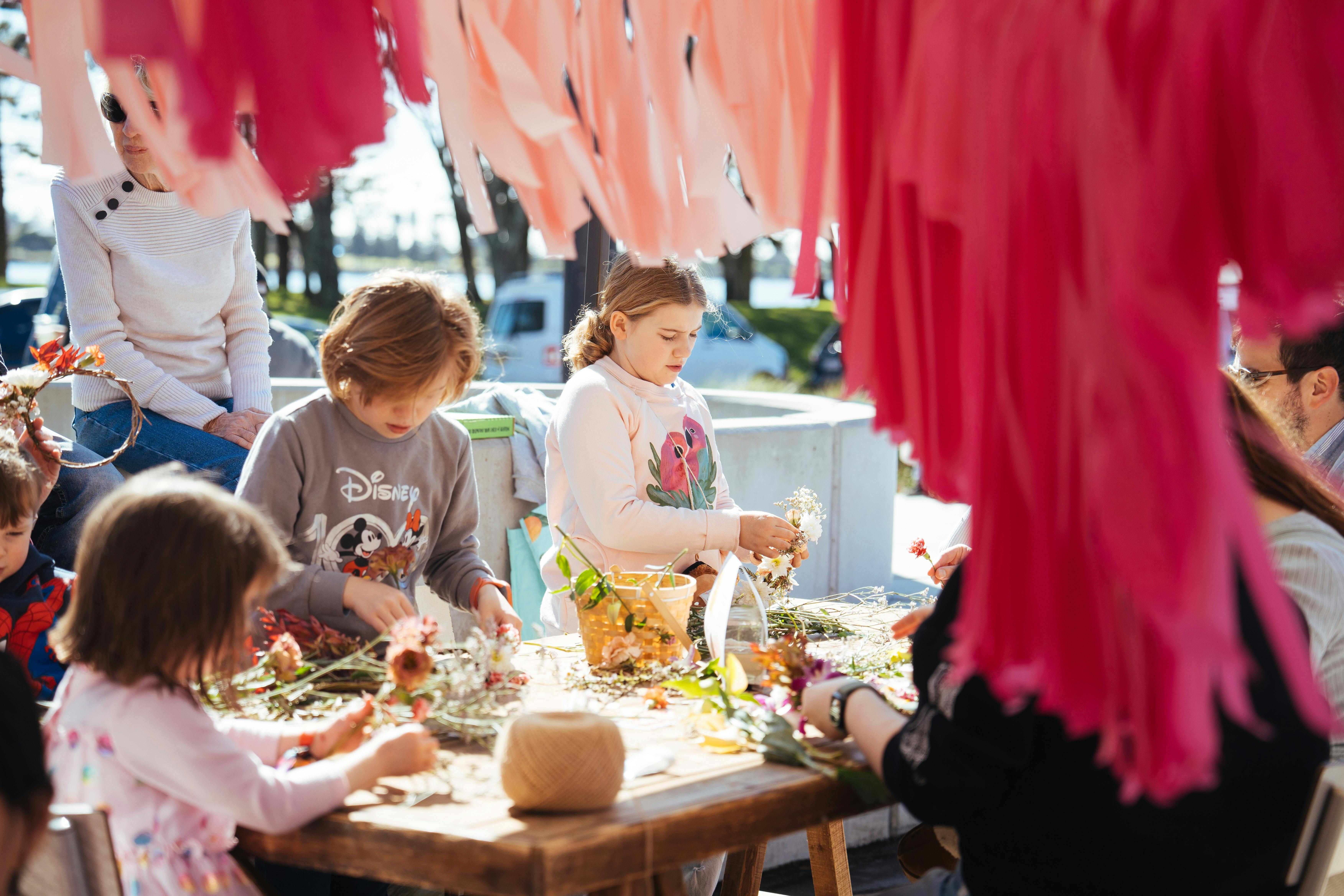 Photo depicts children and families engaging with the monthly workshop