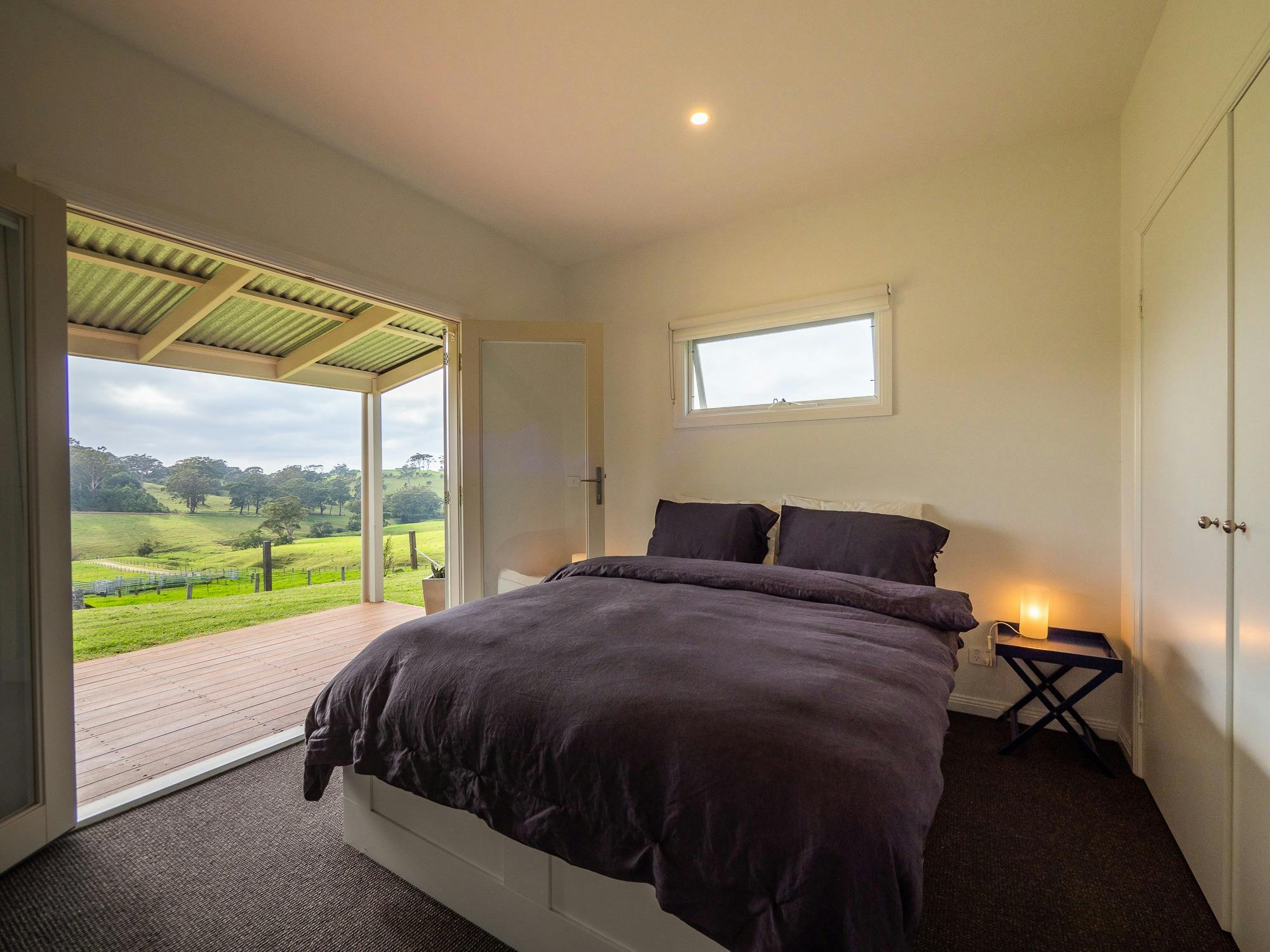 Bedroom opens through French doors to verandah , garden and our beautiful farm