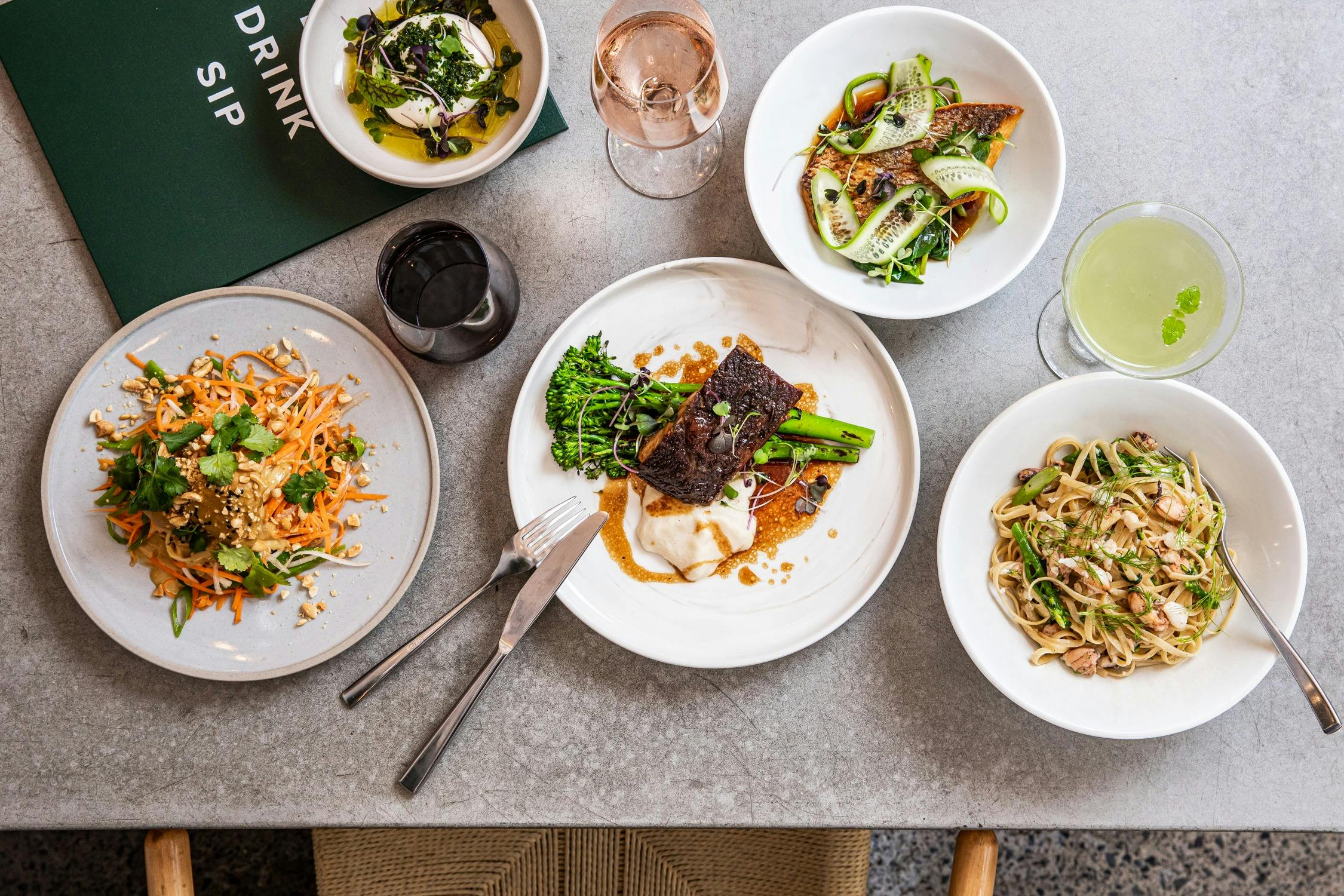 A range of lunch dishes including wagyu brisket, chicken and coconut salad and pasta