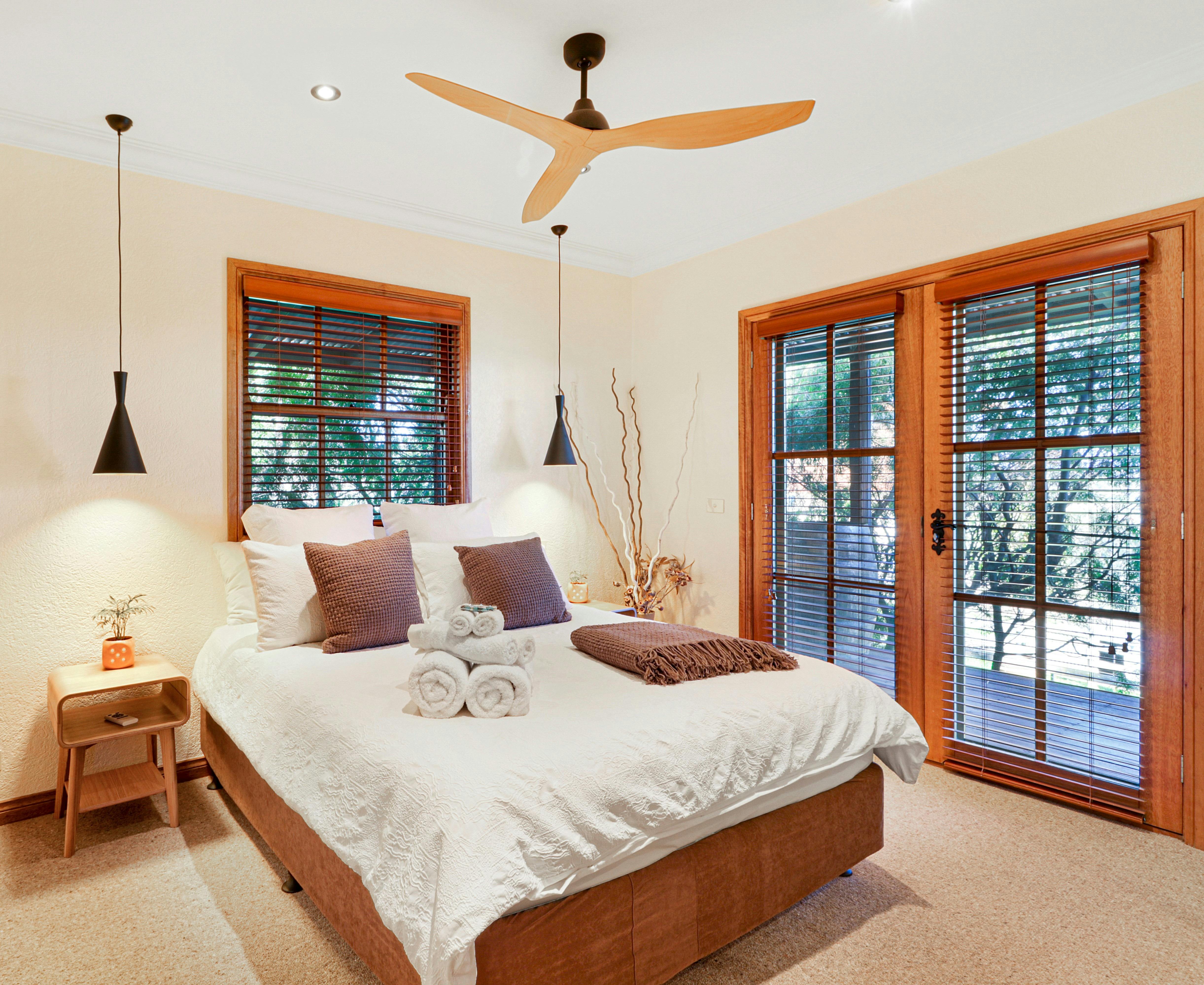 Master bedroom at Stone Creek Cottage features ceiling fan