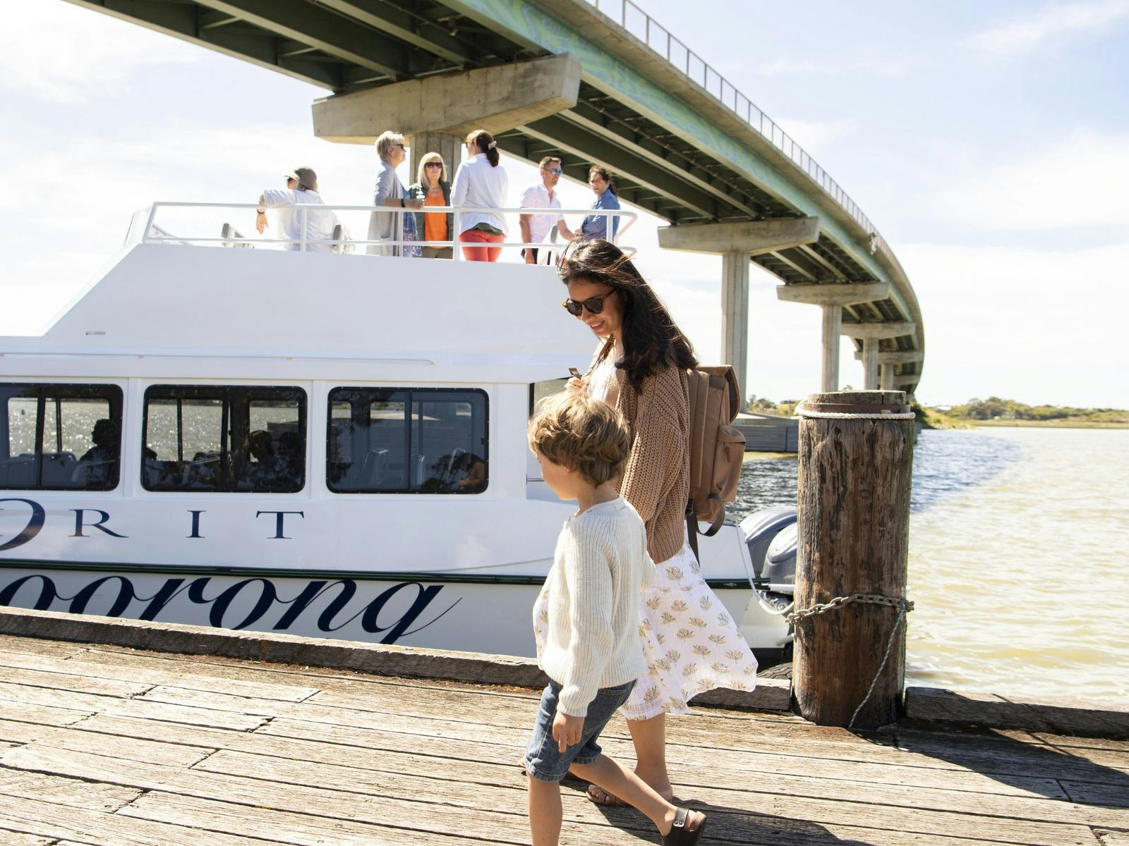 Mother and child walk towards the vessel along the Goolwa Main Wharf
