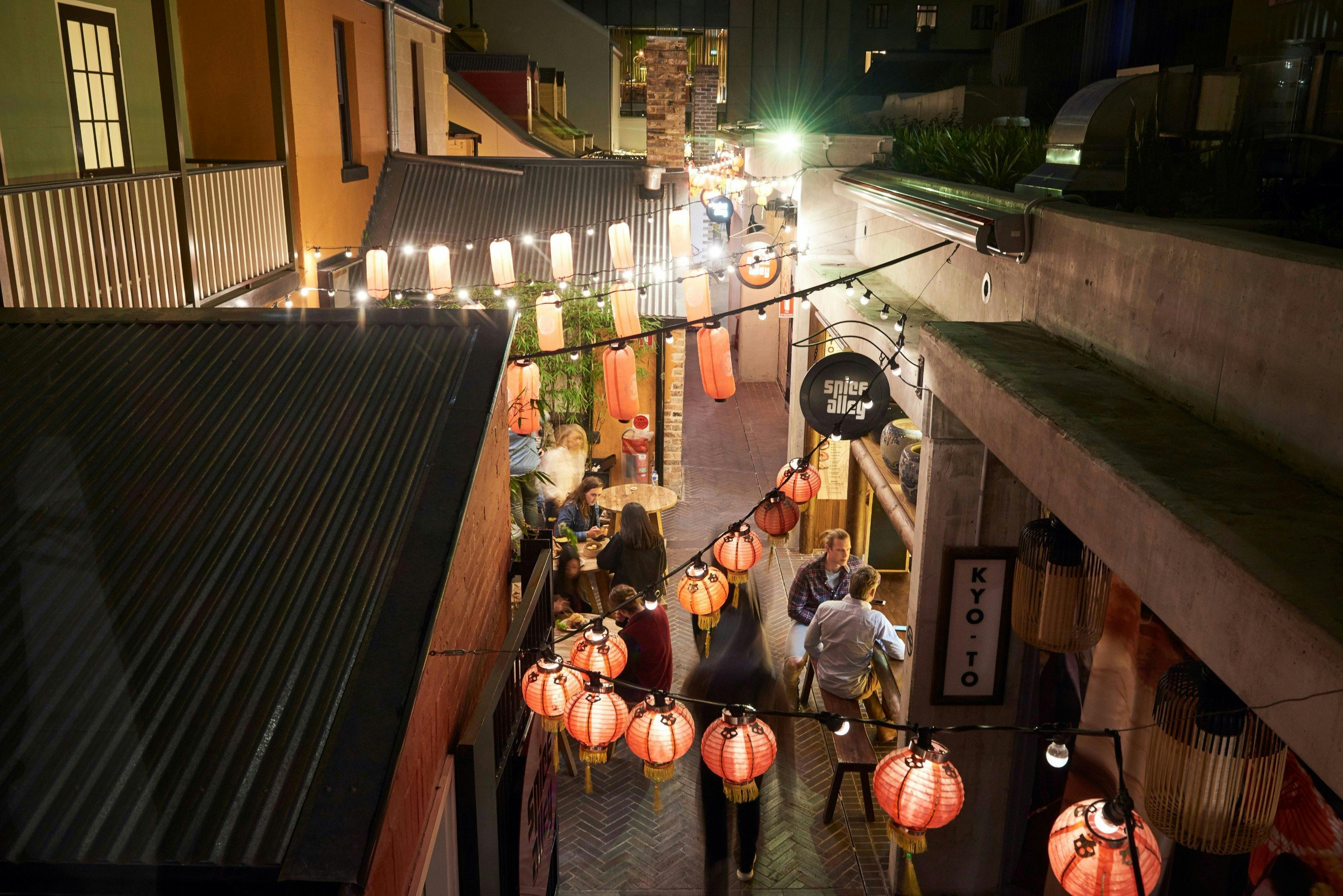 People enjoying Asian hawker-style street food at Spice Alley, Chippendale