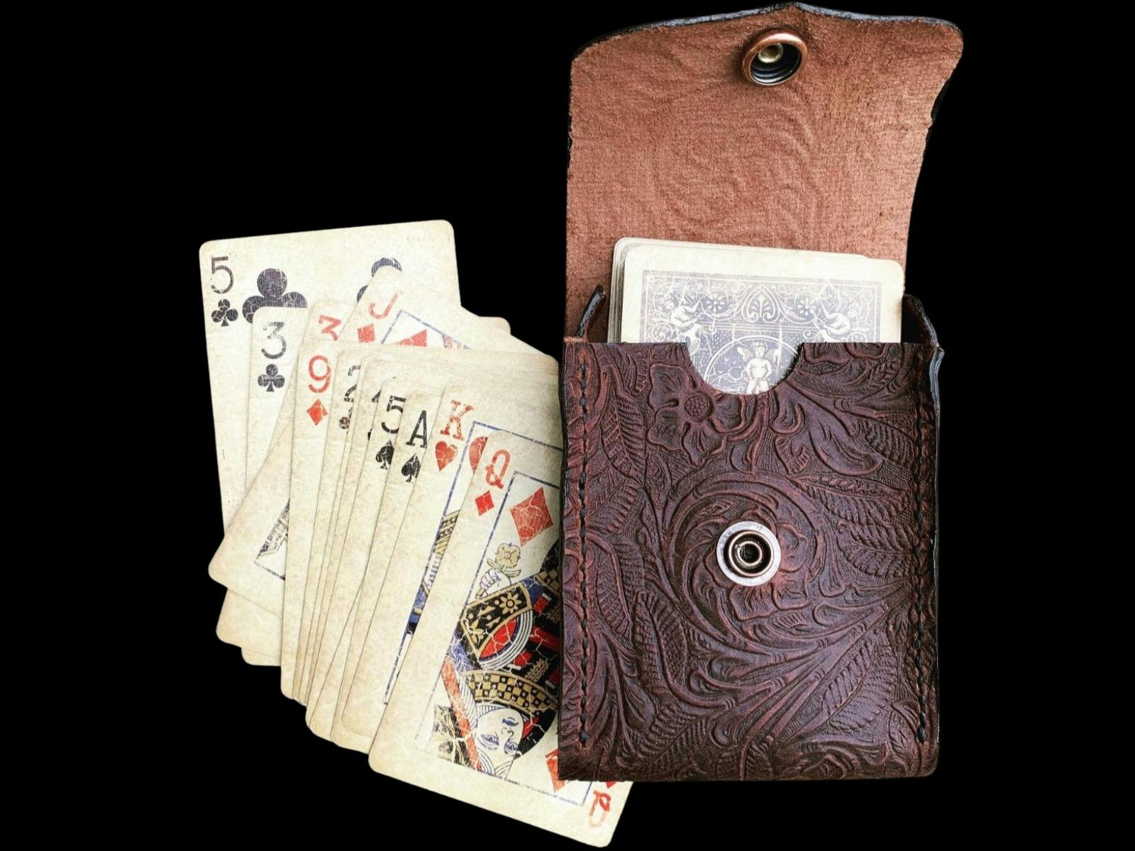 Leather pouch containing deck of cards with other cards laid out beside it