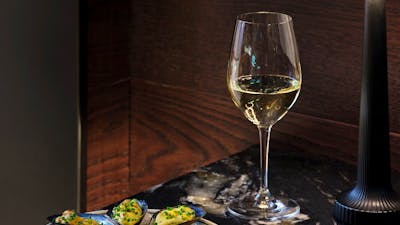 White wine and oysters presented on a table