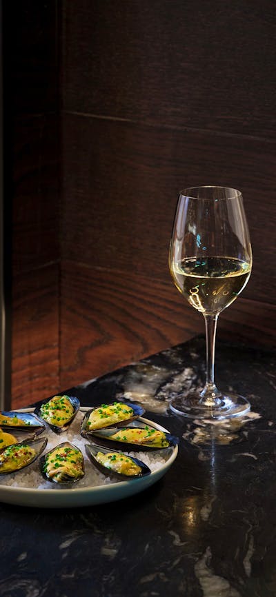 White wine and oysters presented on a table