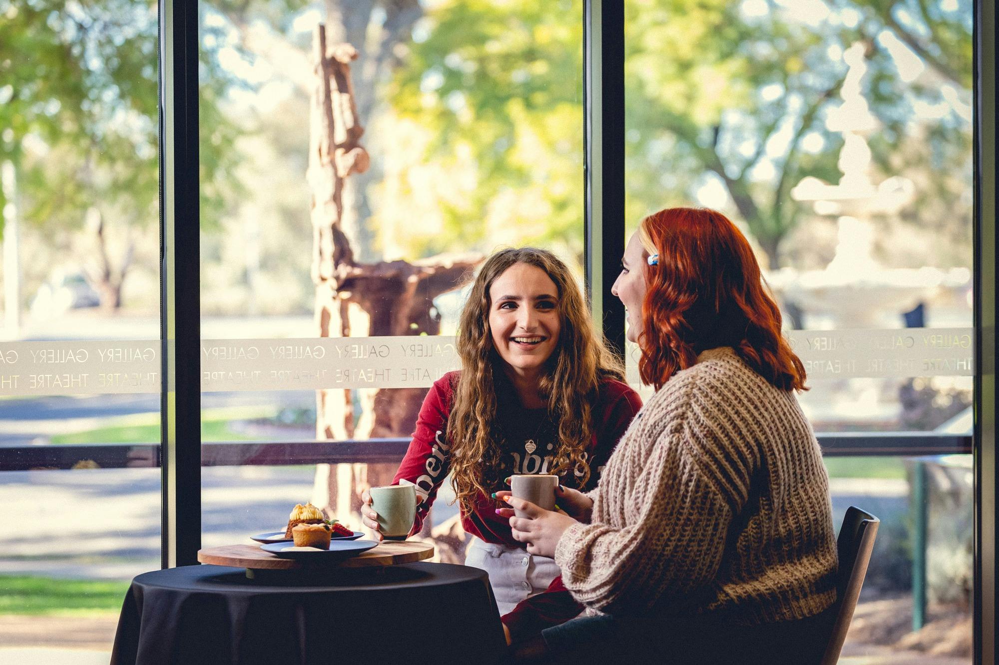 Two customers enjoying coffee and cake at Vista Cafe Bar at Mildura Arts Centre