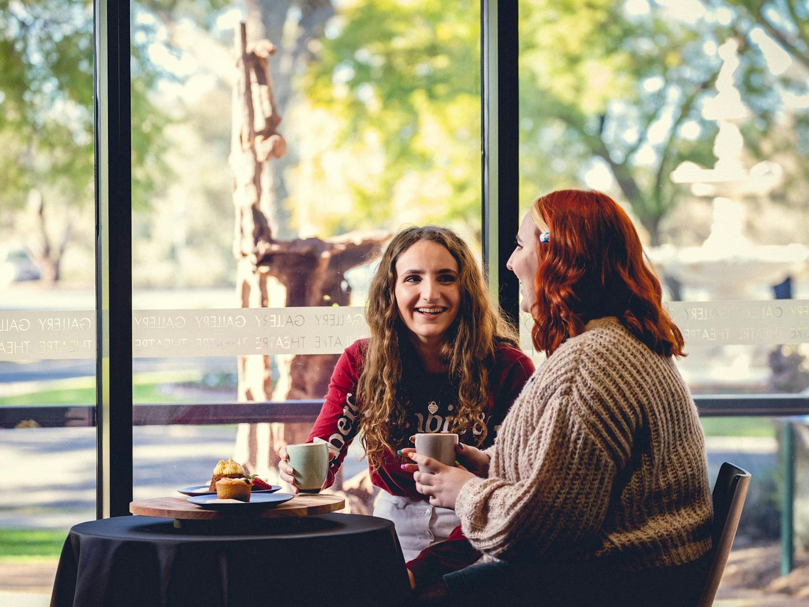 Two customers enjoying coffee and cake at Vista Cafe Bar at Mildura Arts Centre
