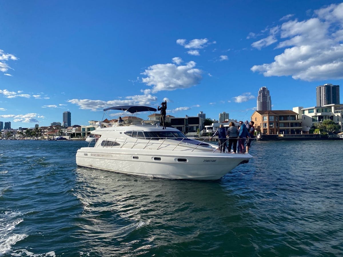 White luxury motor yacht cruising the Broadwater on a sunny day in Gold Coast