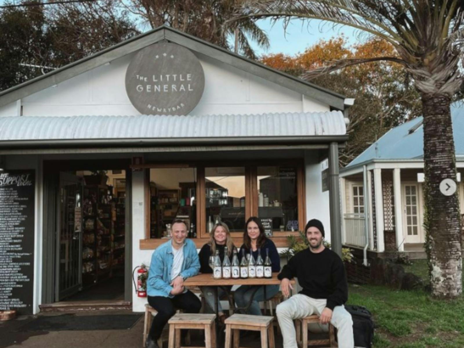 Staff seated outside store