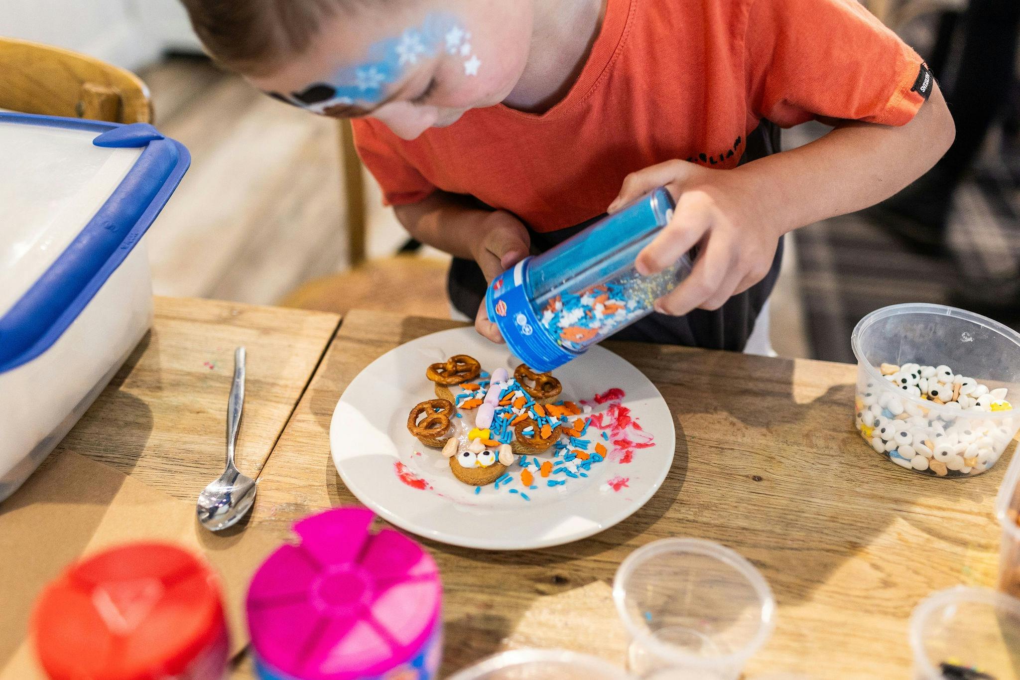 child decorating biscuits