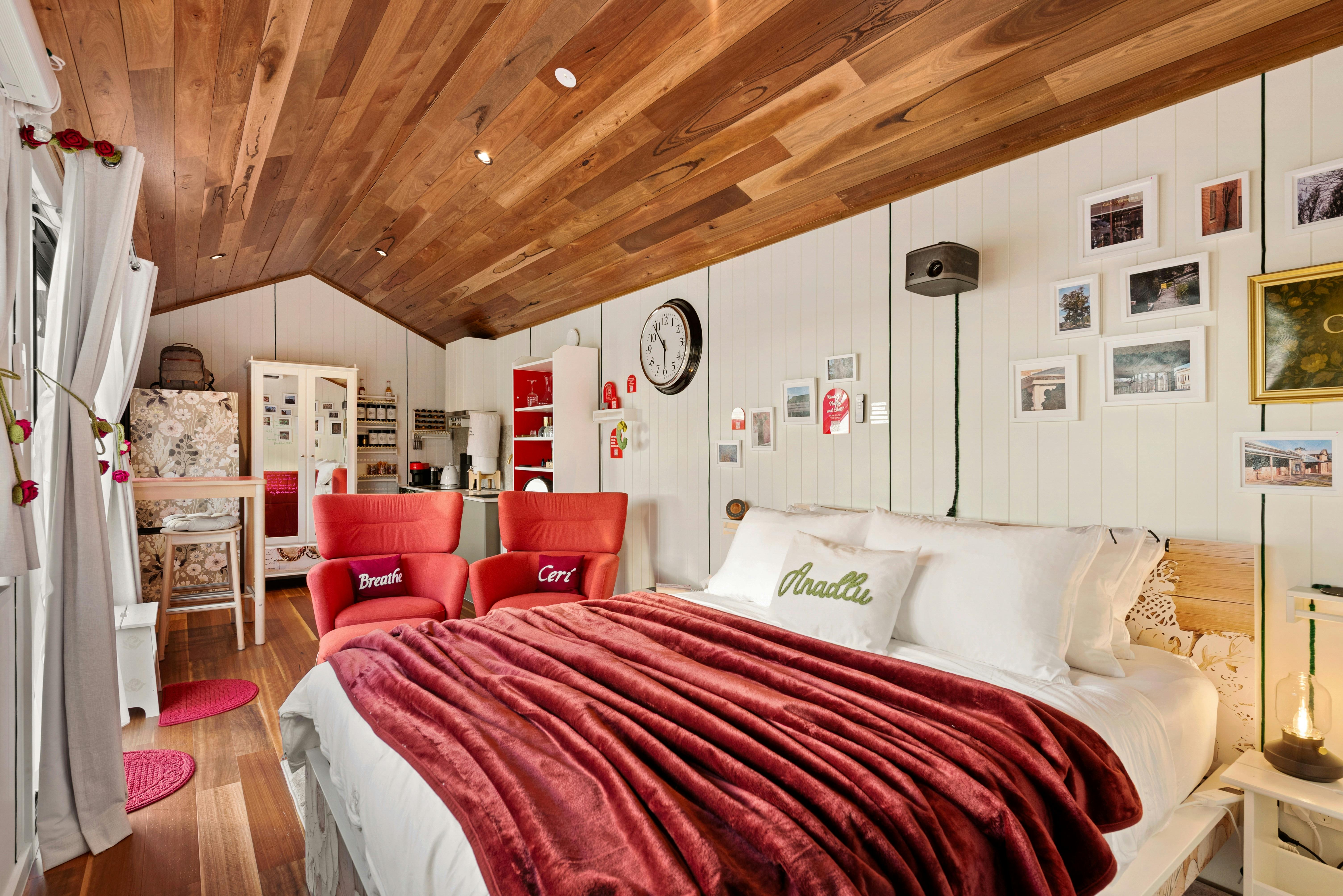 Interior photo showing bed, kitchen and living area