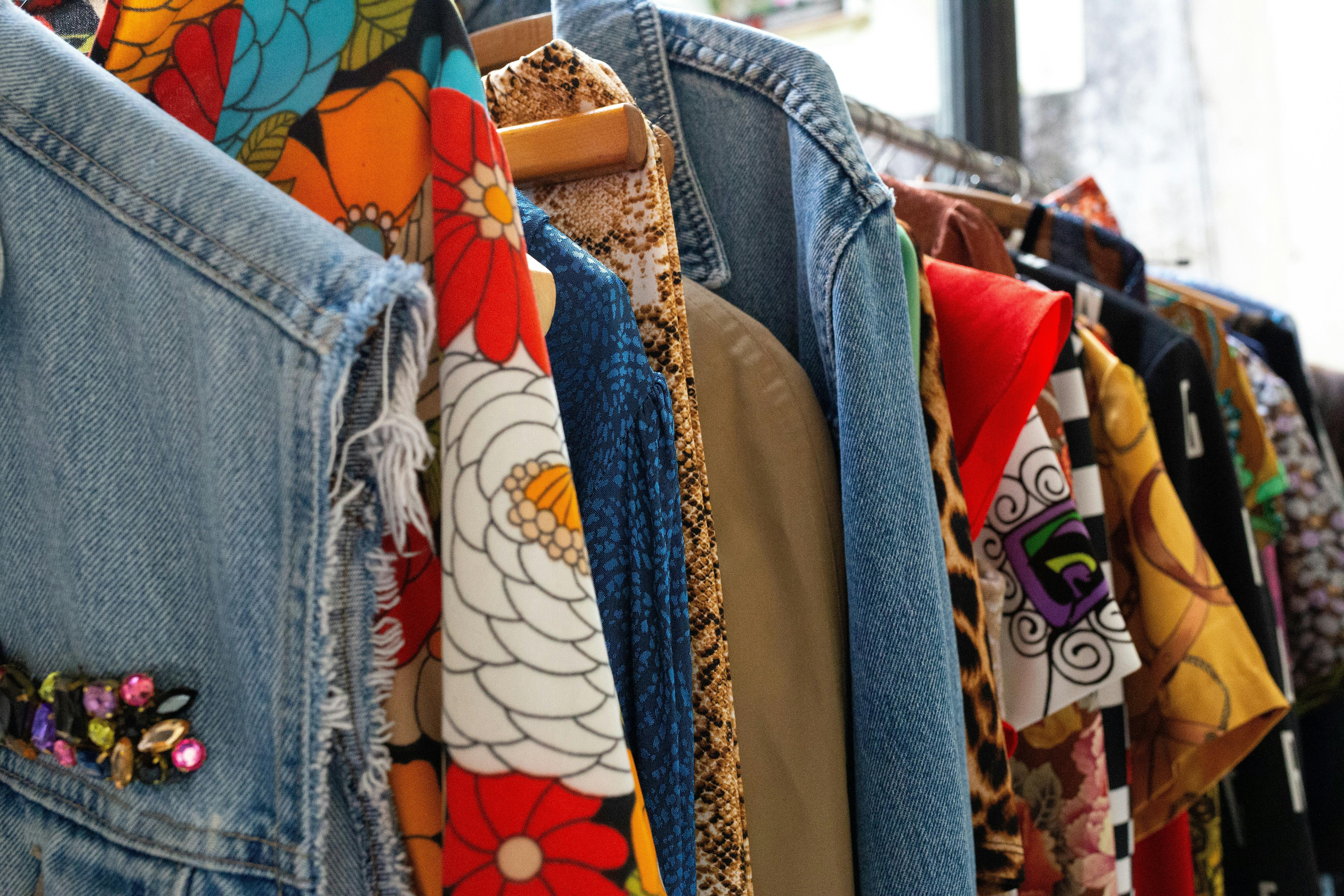 Colourful and patterned clothes, close up and hanging on a rack.