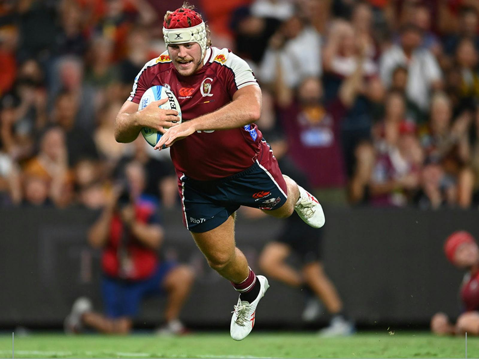 A Queensland Reds player diving for a try