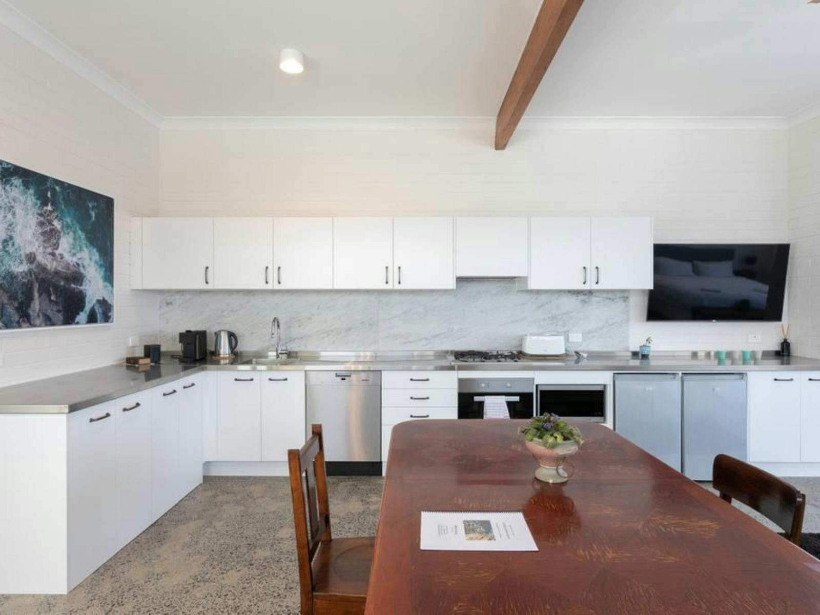 Open-plan living area with large windows showcasing stunning ocean views and natural light.