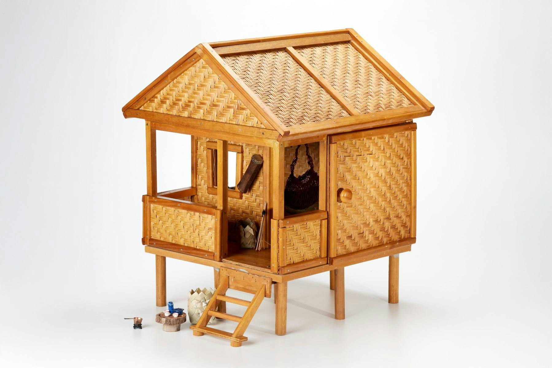 Papua New Guinea styled doll house made of vanished wood and plaited pandanus leaf.