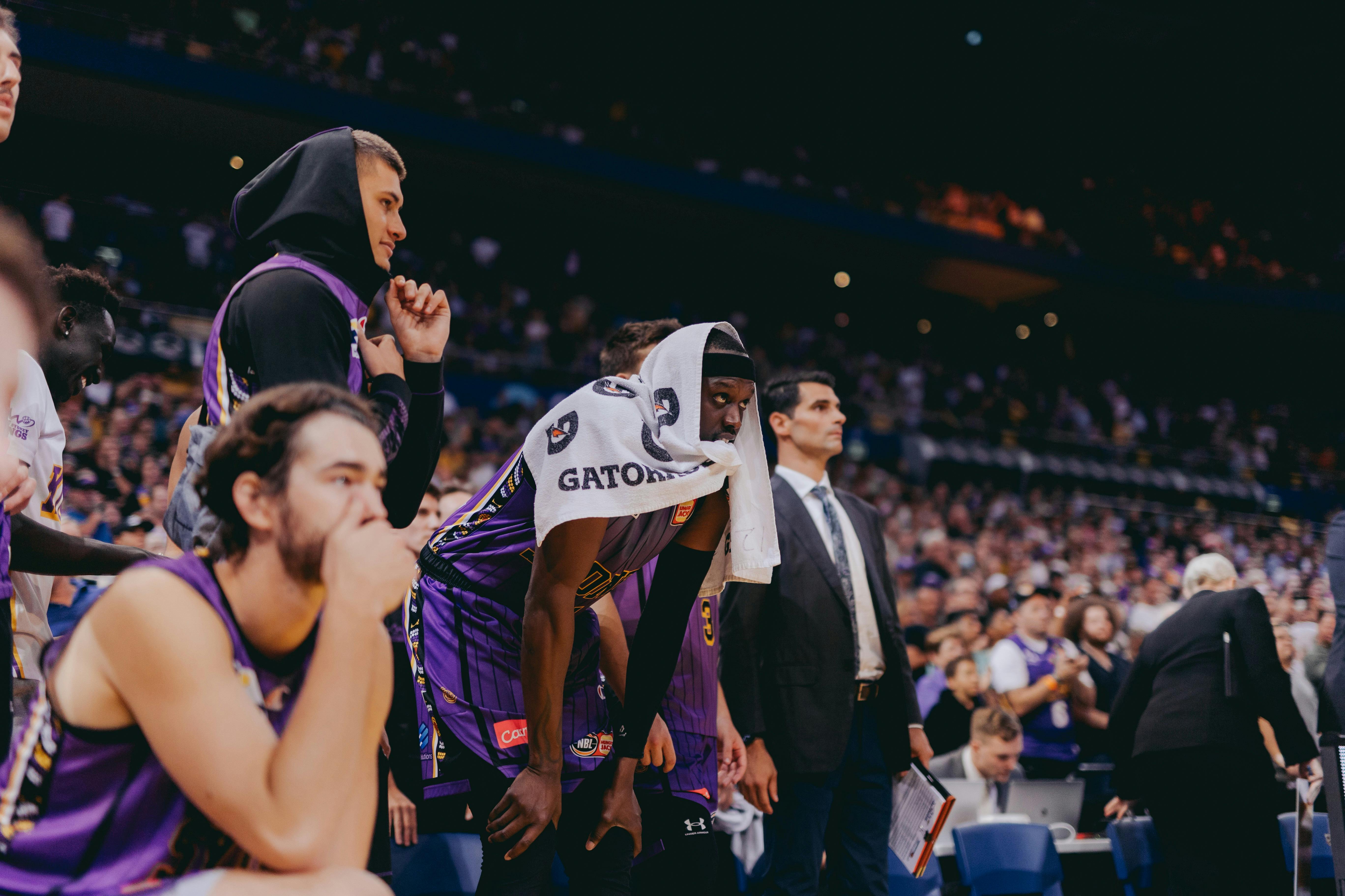Sydney Kings players watch a game from the bench