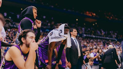 Sydney Kings players watch a game from the bench