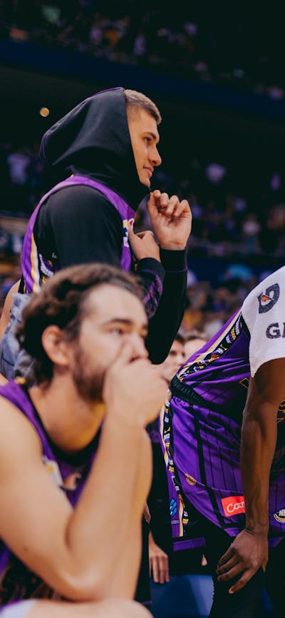 Sydney Kings players watch a game from the bench