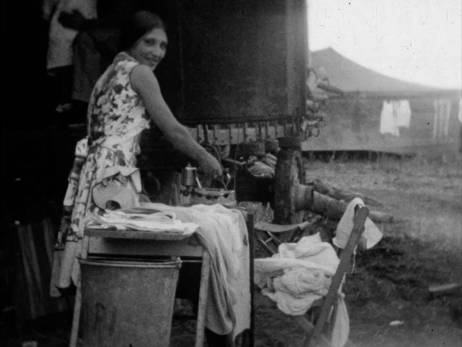 a screen grab from Colleano Heart film preview - black and white image, woman doing laundry