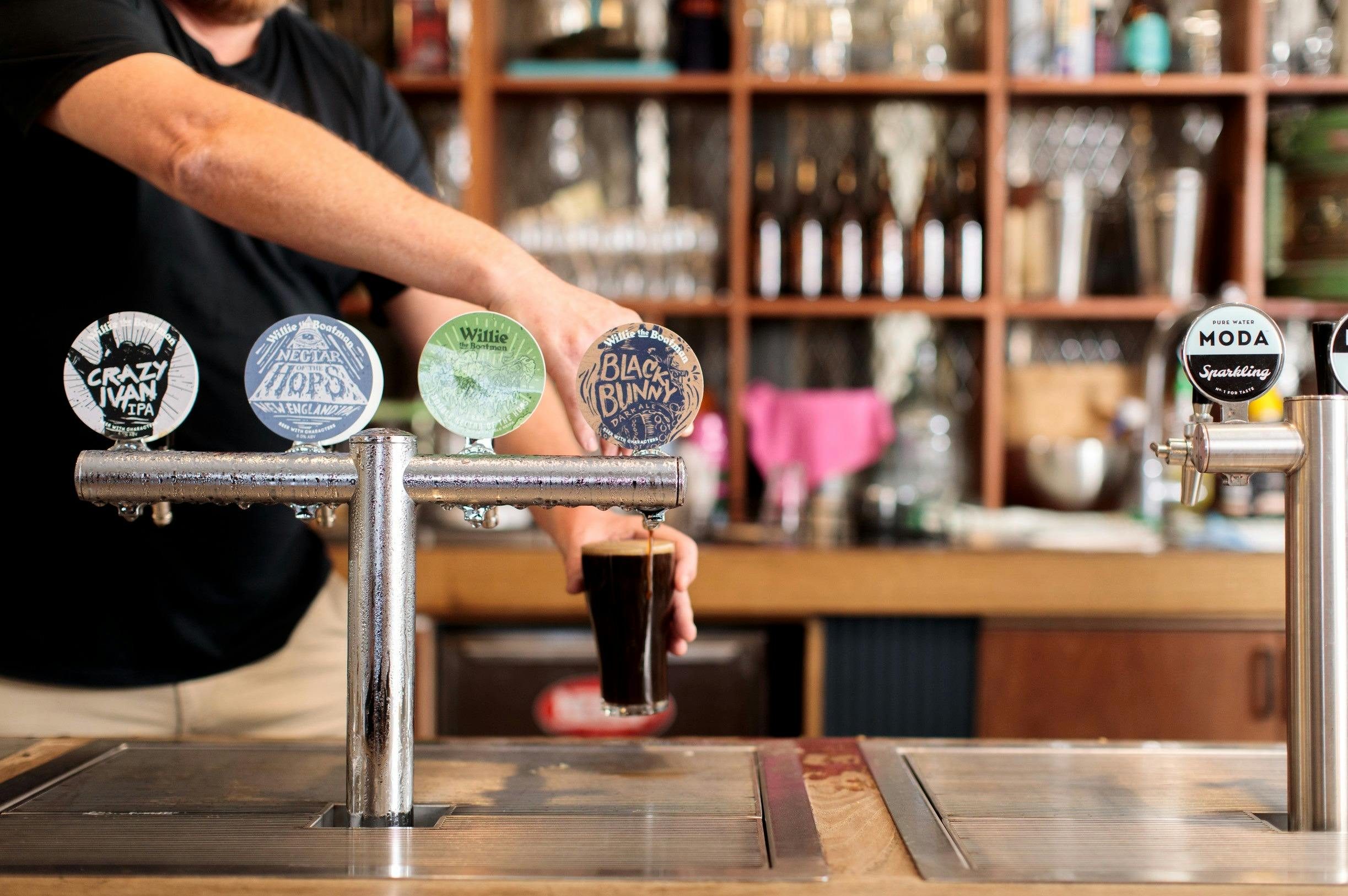 Bartender pouring beers at Willie The Boatman, St. Peters