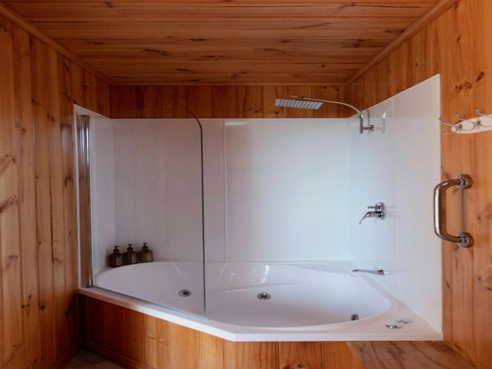 Spa bath and shower in the bathroom. Orana body wash, conditioner and shampoo.