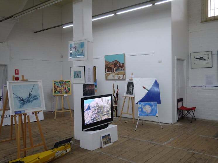 image shows artifacts from the Ice Pact exhibition including paintings of the Antarctic landscape