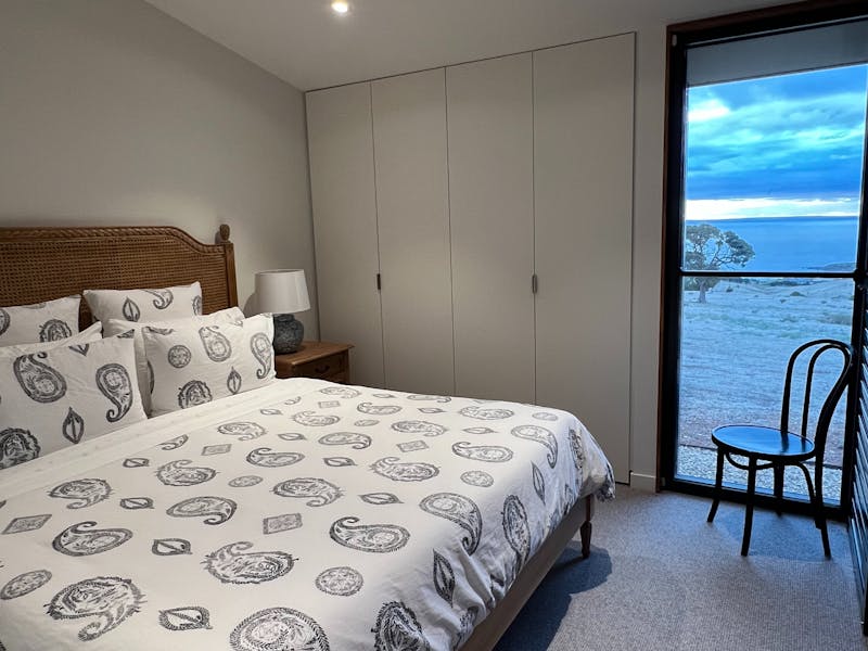 king-size bed, generous cupboard space, and beautiful views across the property toward Kangaroo Isla