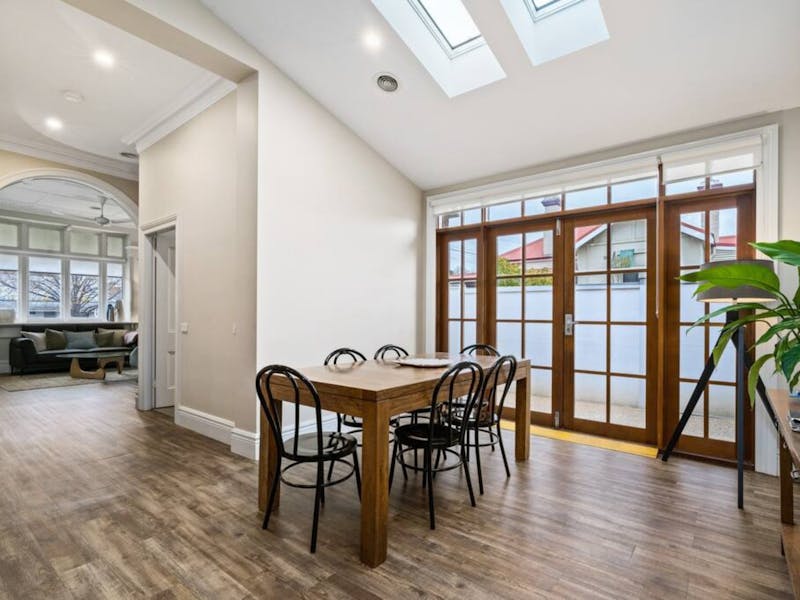 Large Window Doors with Large Dining Table and skylight to allow lots of natural light.