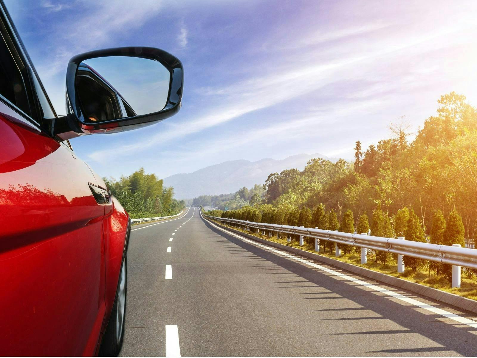 red car on road