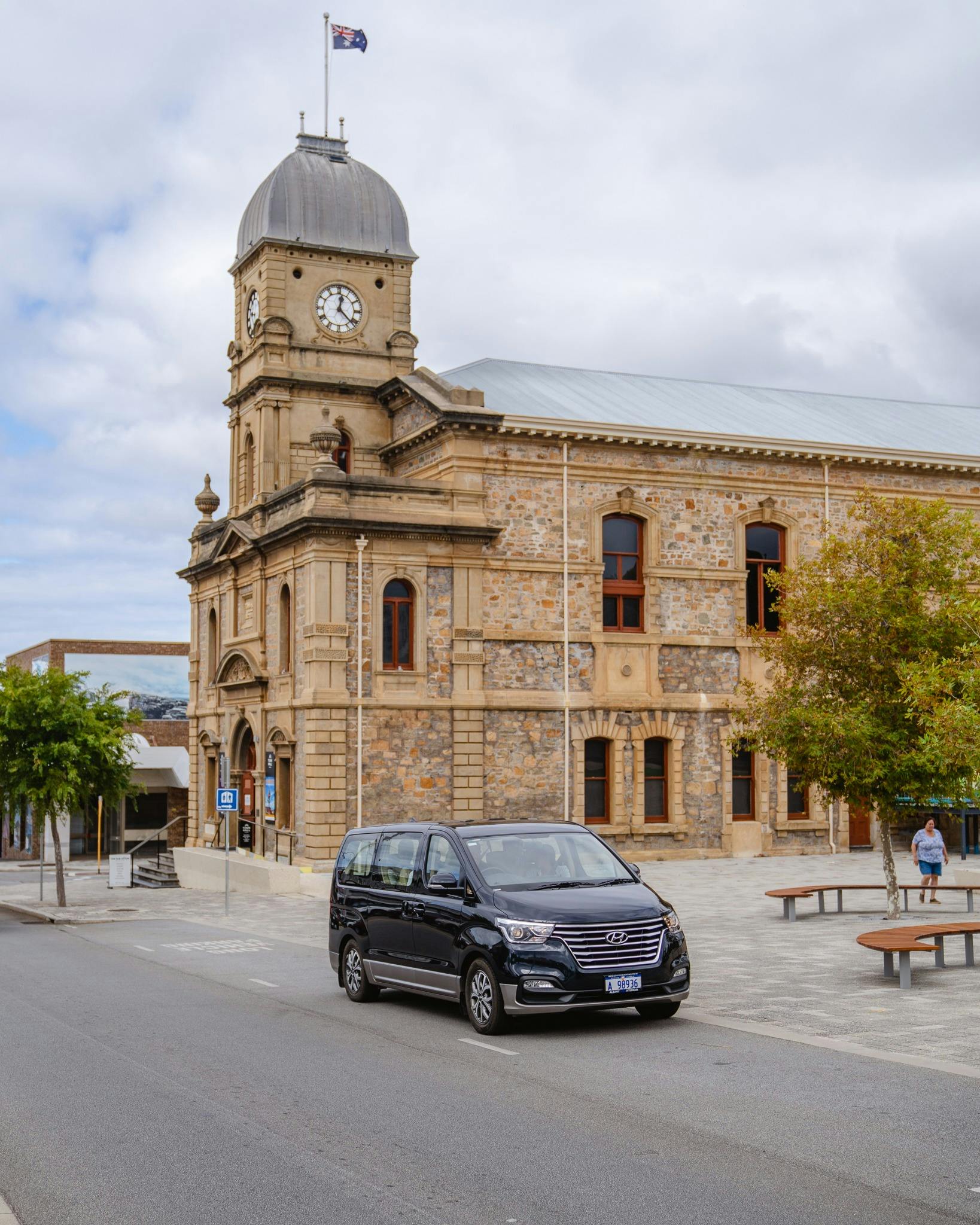 dark blue van parked near granite stone Town Hall