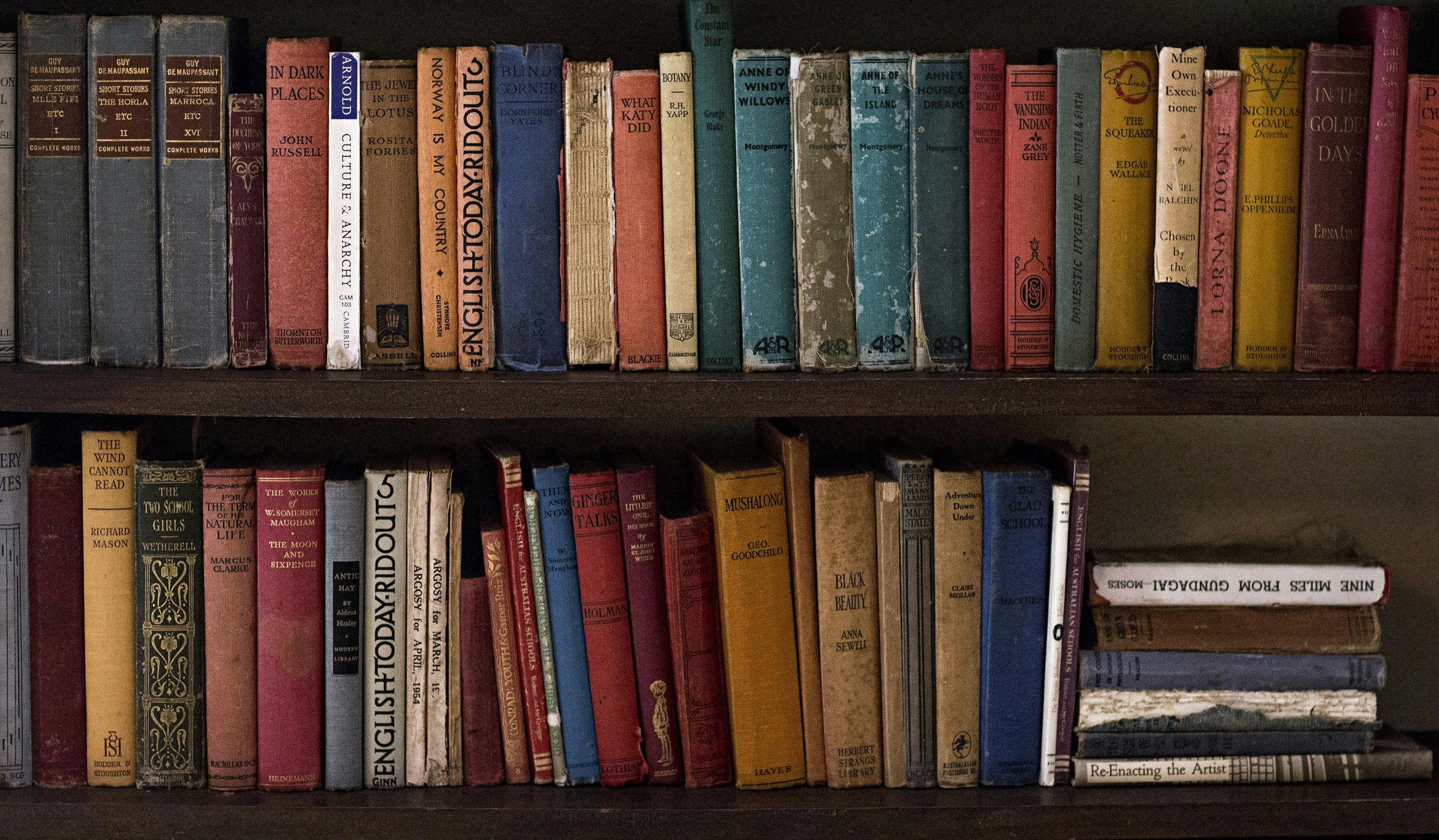 a book shelf filled with old publications