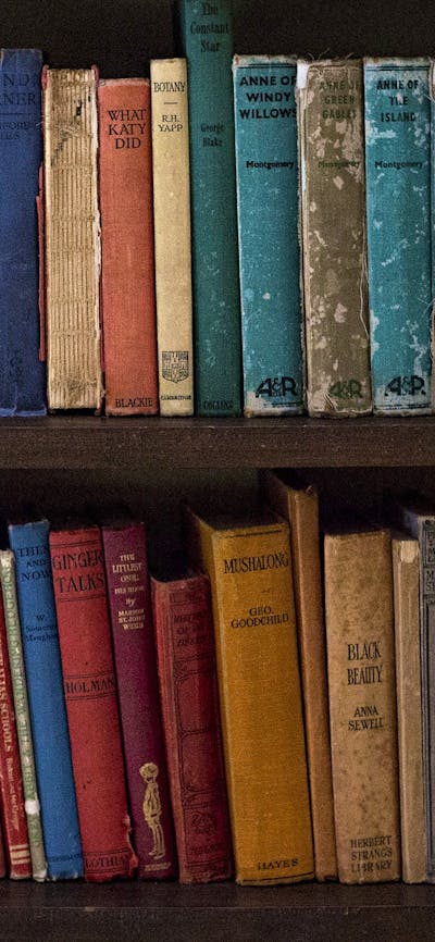 a book shelf filled with old publications