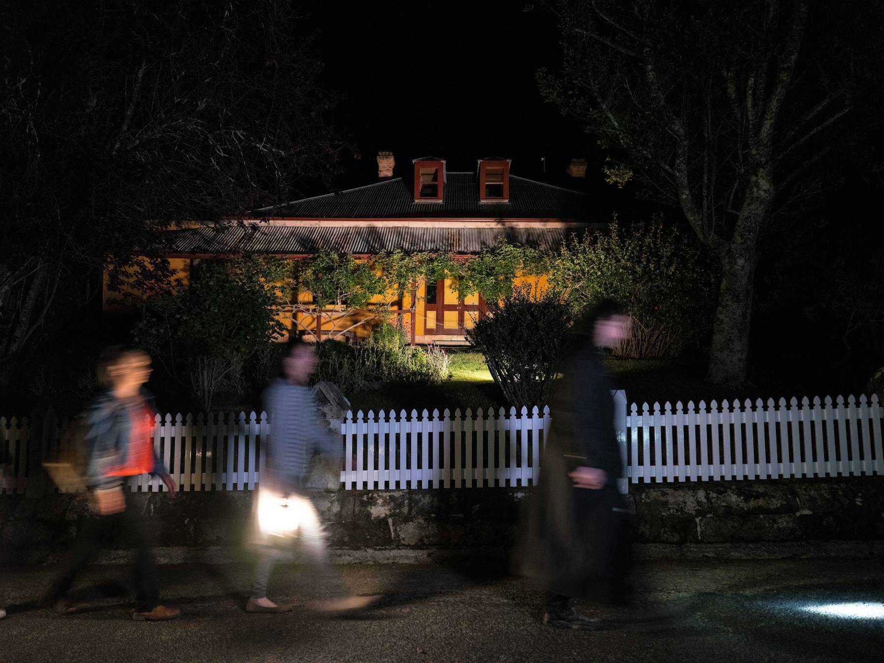 Ghost Tour group walking past a historic building at Port Arthur Historic Site