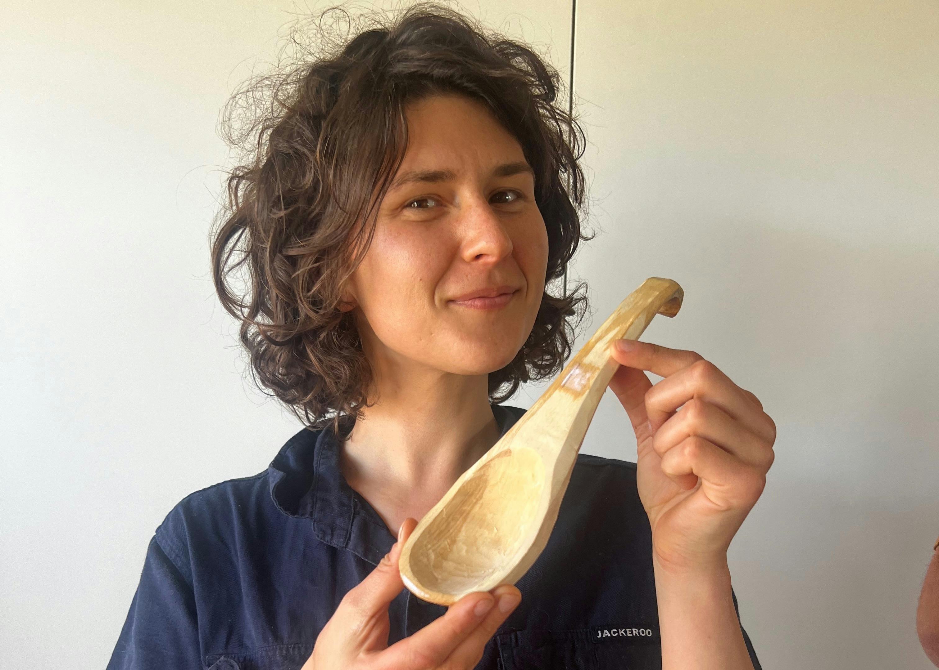 Smiling Participant Holding Her Finished Spoon