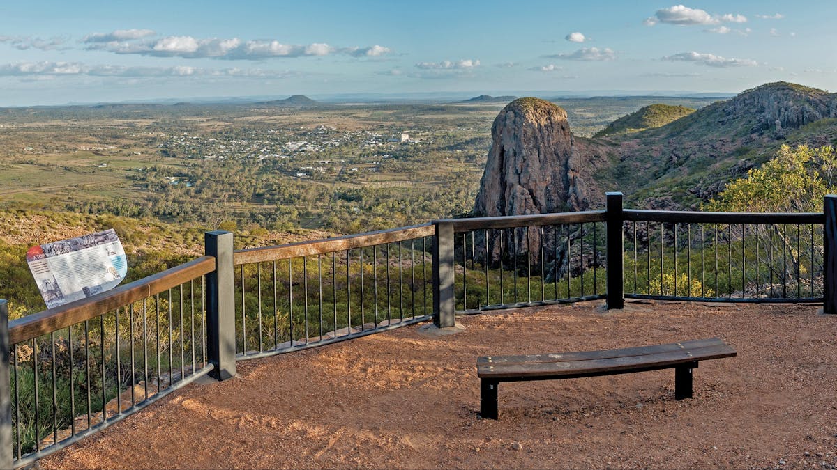 High view of surrounding landscape with bushland and buildings.