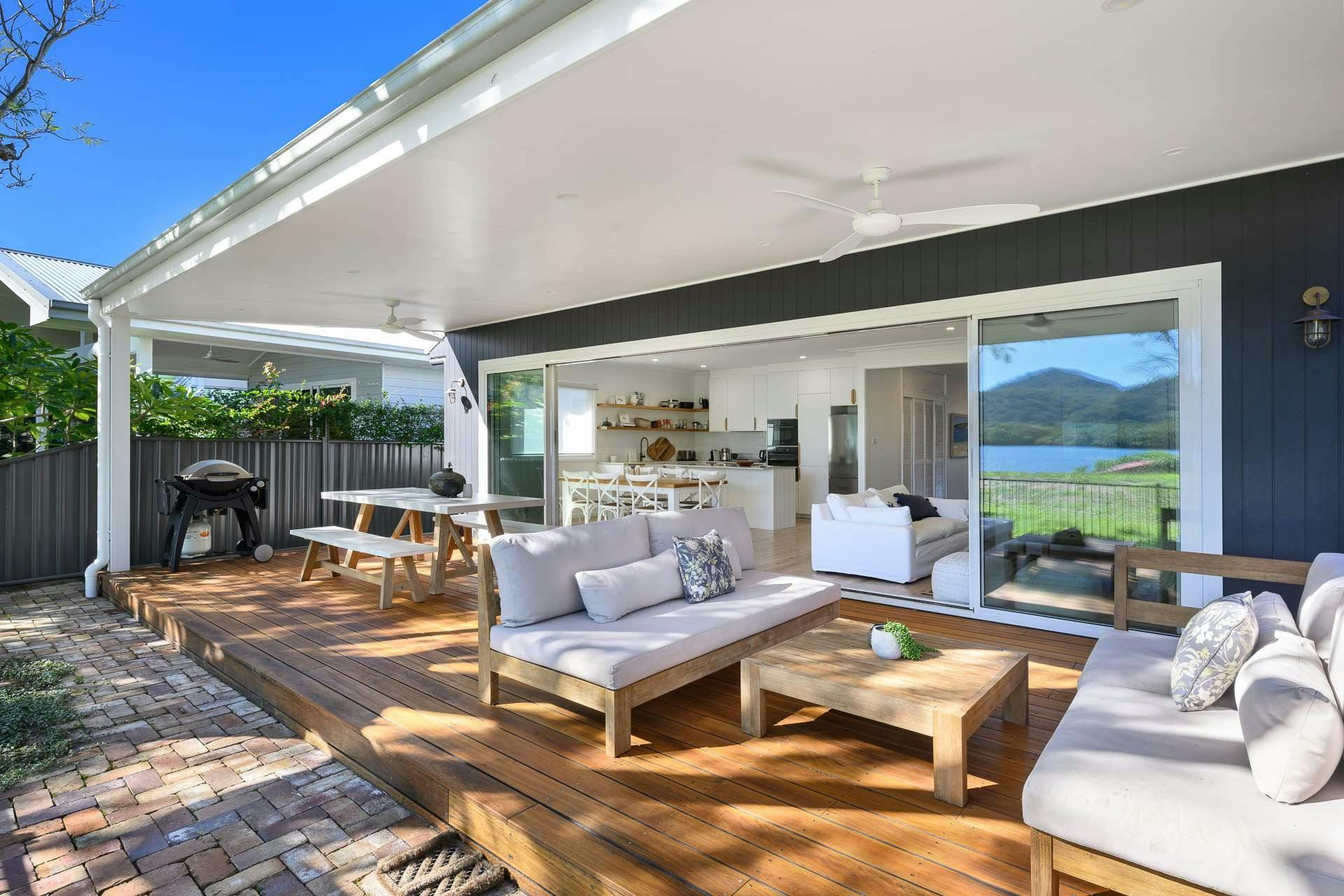 Back deck with large undercover area, outdoor dining table and outdoor lounge